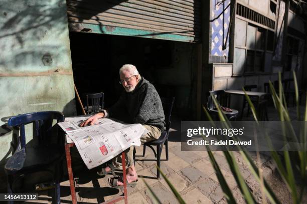 Man reads a paper newspaper in a popular cafe on January 14, 2023 in Cairo, Egypt. The Egyptian pound suffered its biggest one-day drop on January 4...