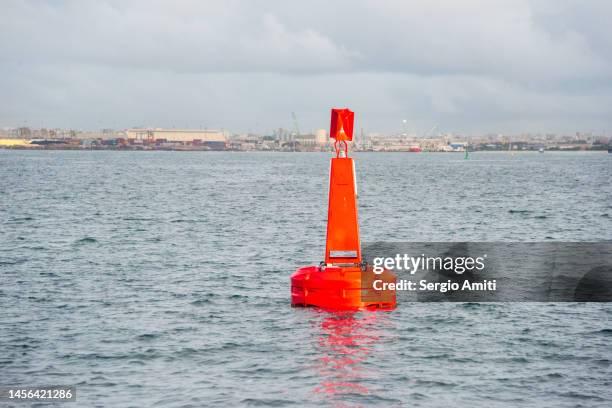 red buoy and goree island seen from sea - boia equipamento marítimo de segurança imagens e fotografias de stock