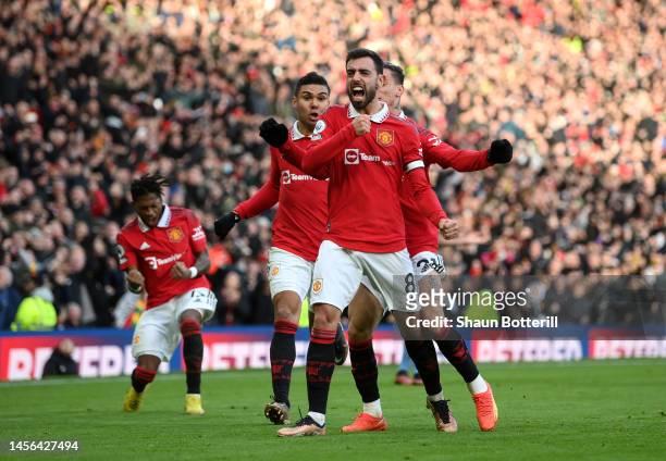 Bruno Fernandes of Manchester United celebrates with team mates Antony and Casemiro after scoring the team's first goal during the Premier League...
