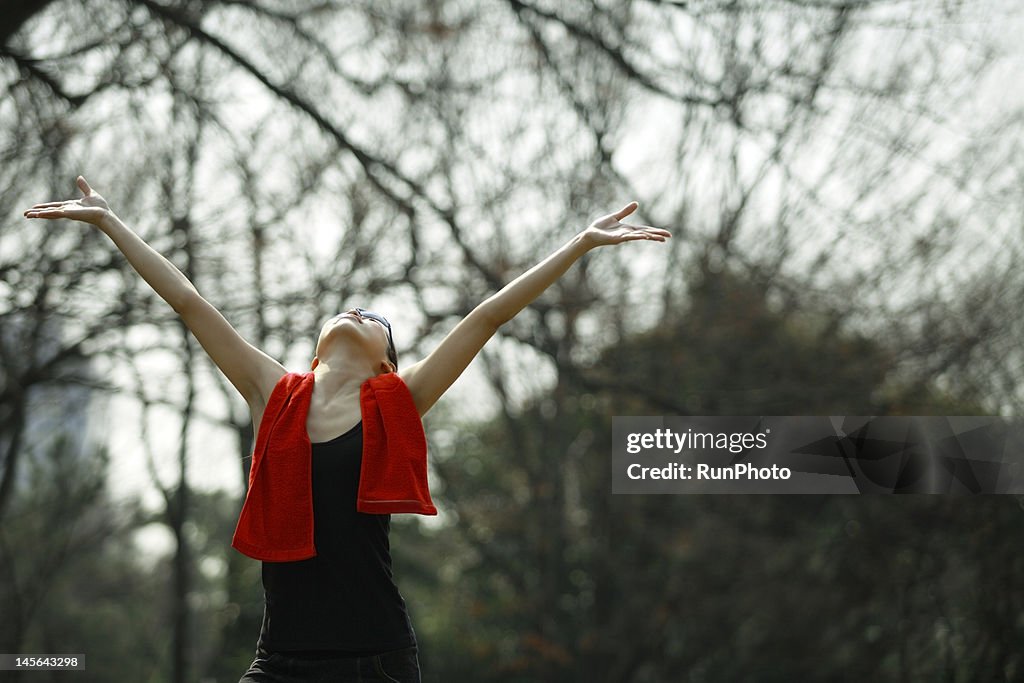 Young woman outstretching arms