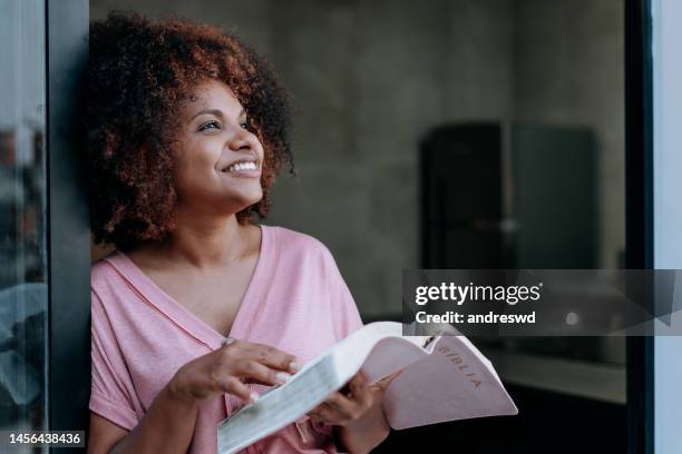 woman reading the bible - black people praying stock pictures, royalty-free photos & images