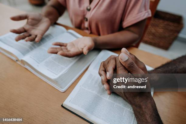 couple praying together - preacher stock pictures, royalty-free photos & images