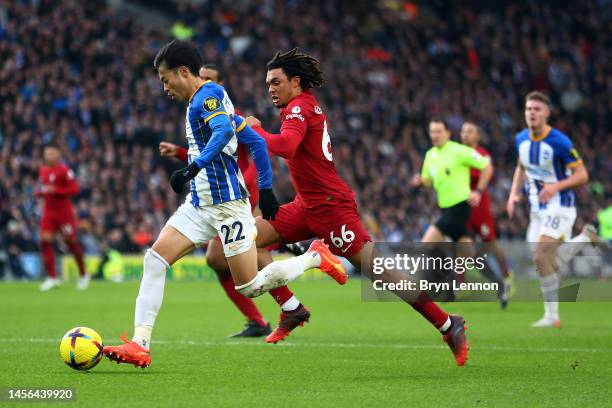 Pascal Gross of Brighton and Hove Albion is challenged by Caoimhin Kelleher of Liverpool during the Premier League match between Brighton & Hove...