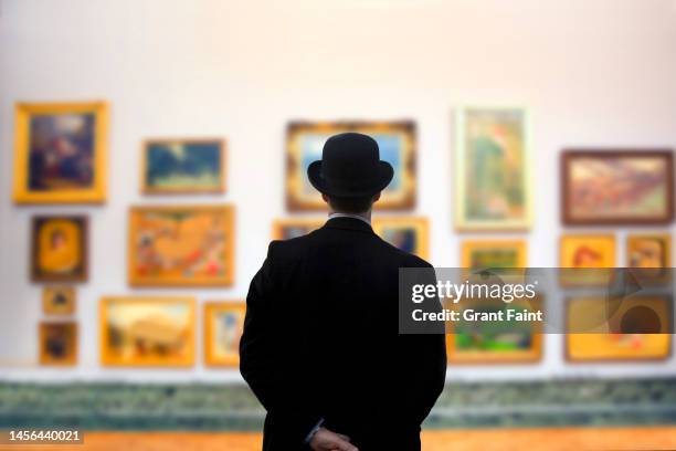 man wearing bowler hat in gallery - exhibition fotografías e imágenes de stock