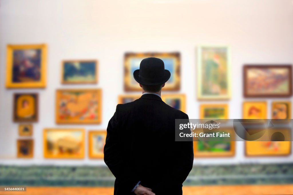 Man wearing Bowler hat in gallery
