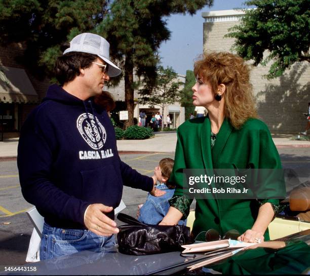 Actor/Director Patrick Duffy speaks with Linda Gray during a break in filming scene, November 16, 1988 in Los Angeles, California.