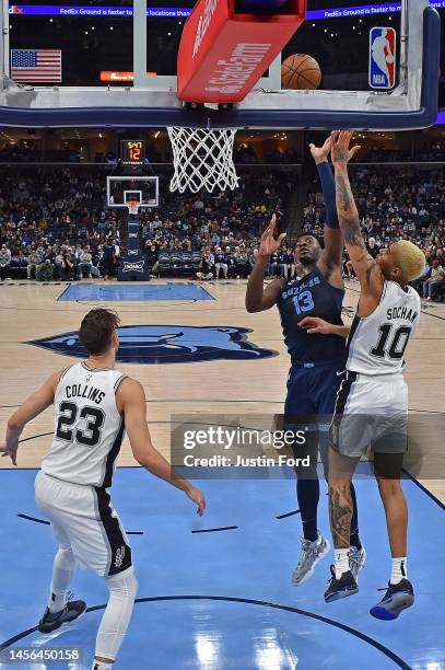 Jaren Jackson Jr. #13 of the Memphis Grizzlies goes to the basket during the game against Jeremy Sochan of the San Antonio Spurs at FedExForum on...