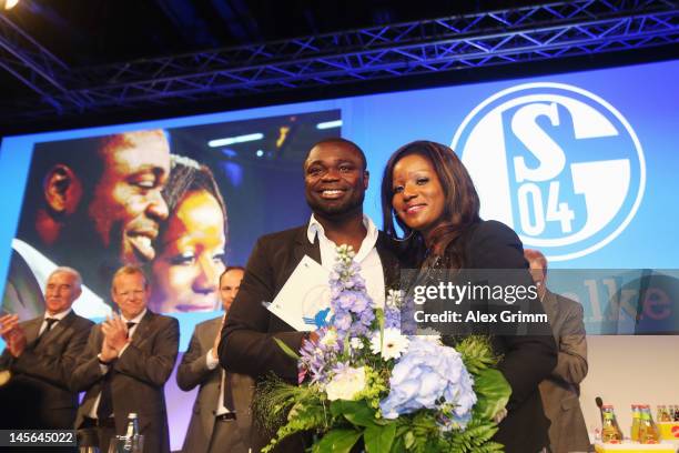 Gerald Asamoah reacts with his wife Linda after being awarded member of the Schalke 'Hall of fame' during the annual meeting of FC Schalke 04 at...