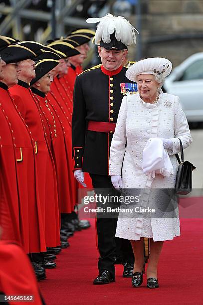 Queen Elizabeth II is greeted by Chelsea pensioners at Chelsea Pier on June 3, 2012 in London, England. For only the second time in its history the...