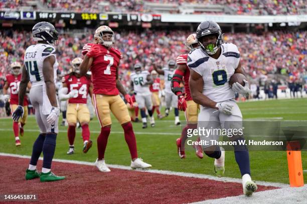 Kenneth Walker III of the Seattle Seahawks scores a 7 yard touchdown against the San Francisco 49ers during the second quarter in the NFC Wild Card...