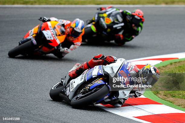 Jorge Lorenzo of Spain and Yamaha Factory Racing Team leads Dani Pedrosa of Spain and Repsol Honda Team and Andrea Dovizioso of Italy and Monster...