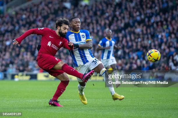 Mohamed Salah of Liverpool FC and Pervis Estupiñan of Brighton & Hove Albion in action during the Premier League match between Brighton & Hove Albion...