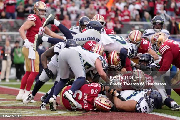 Brock Purdy of the San Francisco 49ers scores a touchdown against the Seattle Seahawks during the third quarter in the NFC Wild Card playoff game at...
