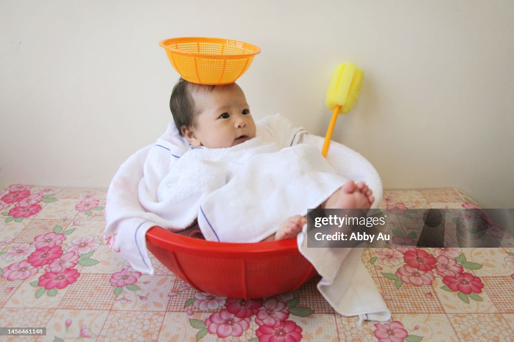 Lovely Asian angel stay in the red plastic basket