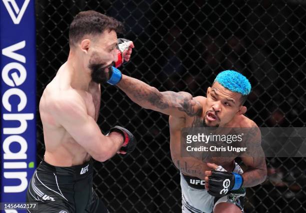 Mateus Mendonca of Brazil punches Javid Basharat of Afghanistan in a bantamweight fight during the UFC Fight Night event at UFC APEX on January 14,...