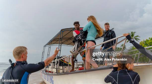 a diving team loading a boat on the indian ocean shore, loading it preparing for an expedition. - wildlife research stock pictures, royalty-free photos & images