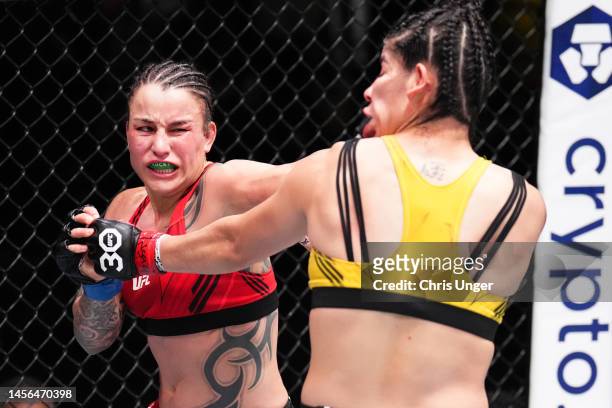 Raquel Pennington punches Ketlen Vieira of Brazil in a bantamweight fight during the UFC Fight Night event at UFC APEX on January 14, 2023 in Las...