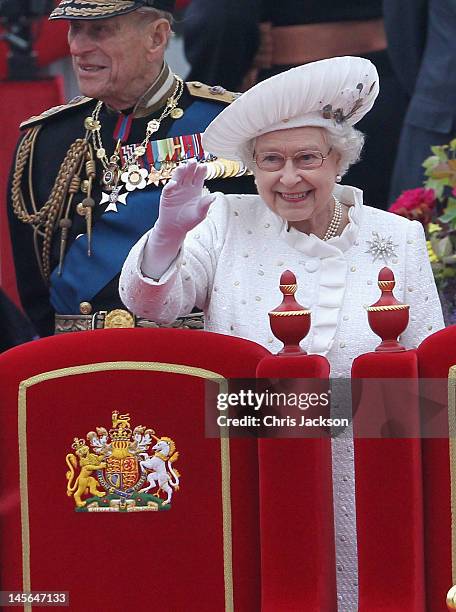 Prince Philip, Duke of Edinburgh and Queen Elizabeth II waves from the Spirit of Chartwell during the Diamond Jubilee Thames River Pageant on June 3,...