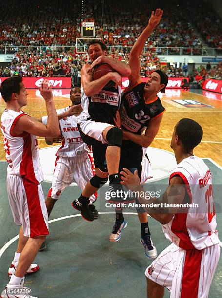 Steven Michael Esterkamp of Ulm and his team mate Dane Watts battle for the ball with Casey Jacobsen of Bamberg and his team mate Brian Roberts...