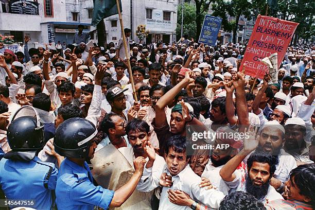 Police stop several thousand militant supporters of an Islamic Alliance on July 14, 1994 from marching to the United States embassy in Dhaka,...