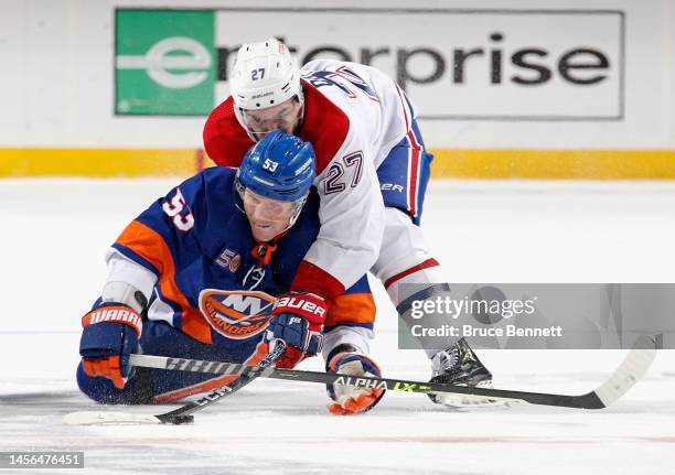 Jonathan Drouin of the Montreal Canadiens knocks down Casey Cizikas of the New York Islanders during the second period at the UBS Arena on January...