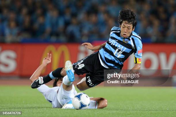 Kengo Nakamura of Kawasaki Frontale is tackled by Kentaro Moriya of Yokohama F.Marinos during the J.League J1 match between Kawasaki Frontale and...