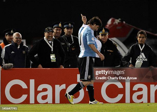 Lionel Messi of Argentina celebrates with the ball under his jersey as there are rumors that his girlfriend Antonella Rocuzzo is pregnant, during a...