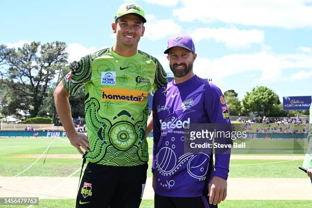 Captains Matthew Wade of the Hurricanes and Chris Green of the Thunder pose for a photo showing their indigenous jerseys during the Men's Big Bash...
