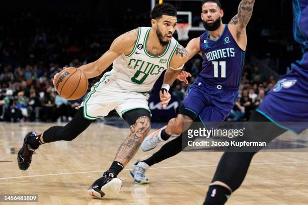 Jayson Tatum of the Boston Celtics drives to the basket while guarded by Cody Martin of the Charlotte Hornets in the fourth quarter during their game...