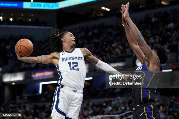 Ja Morant of the Memphis Grizzlies dunks the ball over Jalen Smith of the Indiana Pacers in the third quarter at Gainbridge Fieldhouse on January 14,...
