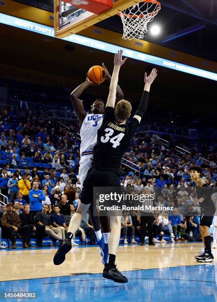 Adem Bona of the UCLA Bruins takes a shot against Lawson Lovering of the Colorado Buffaloes in the second half at UCLA Pauley Pavilion on January 14,...