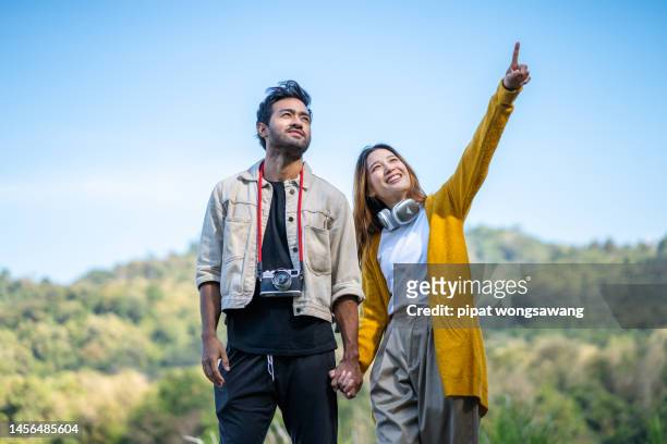couple walking and enjoying nature, tourism concept, leisure, nature, freedom - young couple holding hands stock pictures, royalty-free photos & images