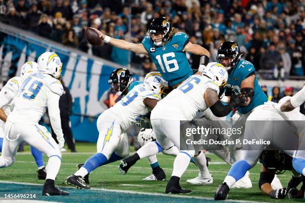 Trevor Lawrence of the Jacksonville Jaguars dives for a two point con in the AFC Wild Card playoff game at TIAA Bank Field on January 14, 2023 in...