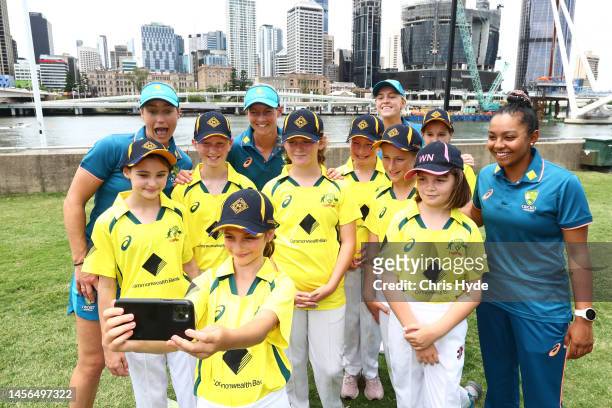 Australian players Alana King, Meg Lanning, Kim Garth and Ellyse Perry pose with junior cricketers ahead of the Womens international series between...