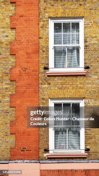 brick facade and two windows with curtain in london - façade stock pictures, royalty-free photos & images