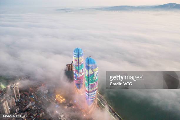 Aerial view of Xiamen Shimao Straits Towers surrounded by advection fog on January 14, 2023 in Xiamen, Fujian Province of China.