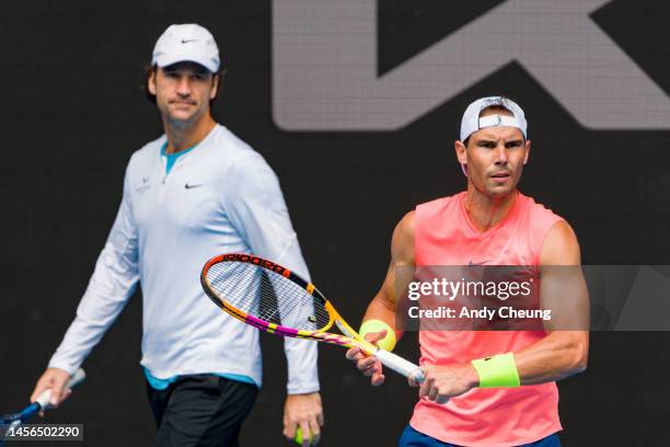 Rafael Nadal of Spain is seen with coach Carlos Moya during a practice session ahead of the 2023 Australian Open at Melbourne Park on January 15,...