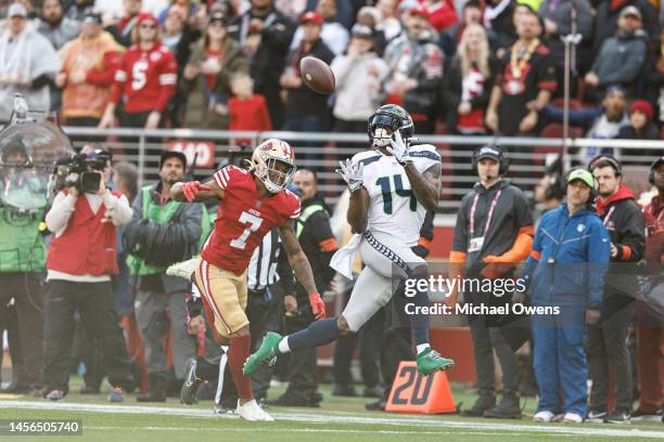 Metcalf of the Seattle Seahawks completes a pass and runs for a touchdown against Charvarius Ward of the San Francisco 49ers during an NFL football...