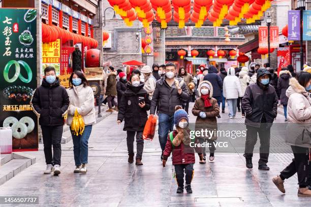 People visit an ancient cultural street decorated with red lanterns during the Little New Year on January 14, 2023 in Tianjin, China. Little New Year...