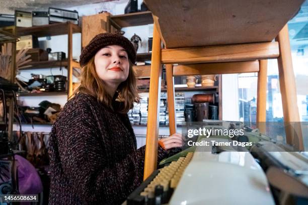 a woman goes shopping in an antique shop - antique shop stock pictures, royalty-free photos & images