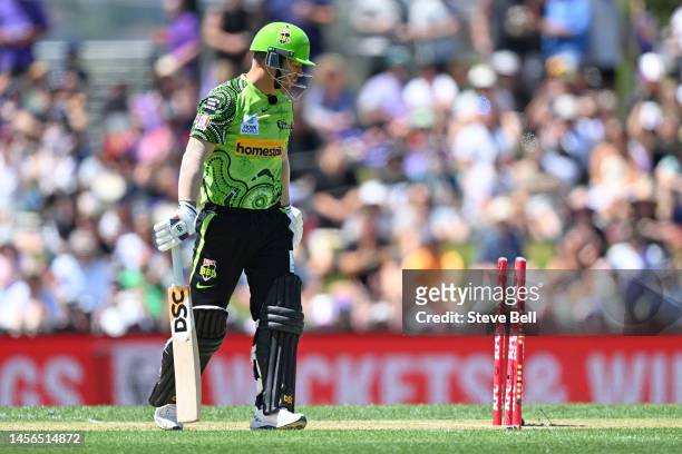 David Warner of the Thunder is bowled by Riley Meredith of the Hurricanes during the Men's Big Bash League match between the Hobart Hurricanes and...