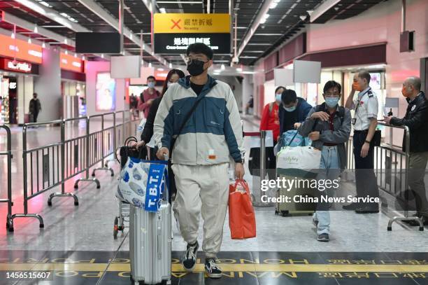 JANUARy 15: Passengers with luggage are seen at Hong Kong West Kowloon Station on January 15, 2023 in Hong Kong, China. Hong Kong and the Chinese...
