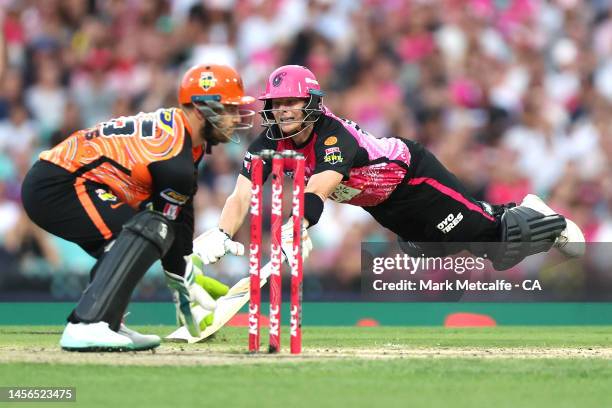 Steve Smith of the Sixers dives to make his crease during the Men's Big Bash League match between the Sydney Sixers and the Perth Scorchers at Sydney...