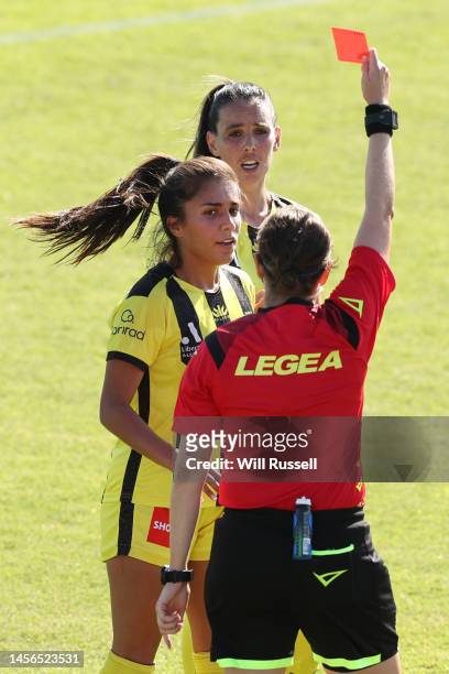 Referee Casey Reibelt shows a red card to Emma Rolston of the Phoenix during the round 10 A-League Women's match between Perth Glory and Wellington...