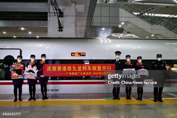 Staff members hold a sign at Guangzhou South Railway Station to celebrate the resumption of high-speed rail services on January 15, 2023 in...