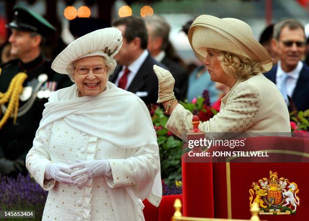 Britain's Queen Elizabeth II and Camilla, Duchess of Cornwall, stand onboard the Spirit of Chartwell during the Thames Diamond Jubilee Pageant on the...