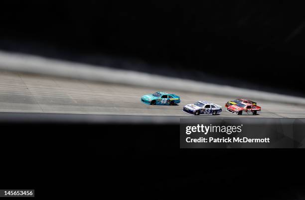 Mark Martin, driver of the Aaron's Dream Machine Toyota, and Jimmie Johnson, driver of the Lowe's Madagascar Chevrolet, lead Clint Bowyer, driver of...