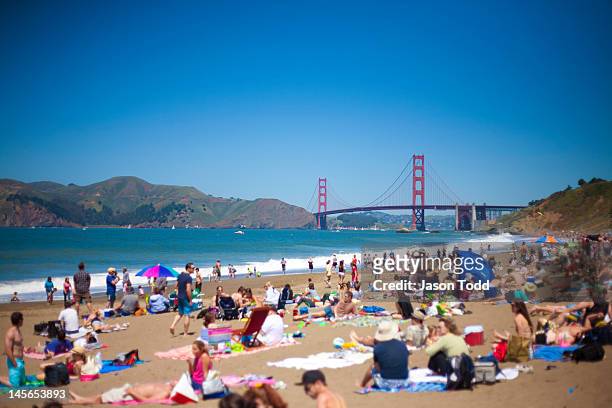 beach goers at baker beach with golden gate bridge - baker beach stock pictures, royalty-free photos & images