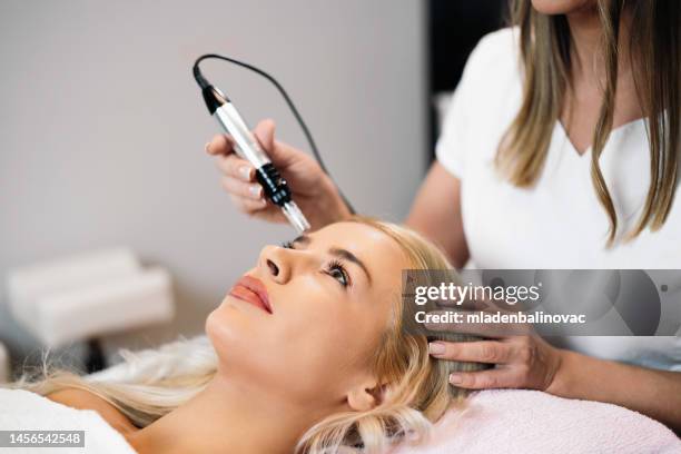 beautiful young woman at beauty clinic - medical procedure stock pictures, royalty-free photos & images