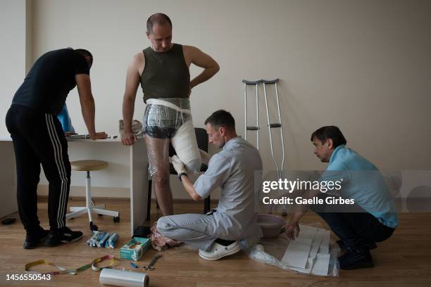 Yuri, prosthetist doctor and his team, makes a plaster mold of Danylo's thigh, these measurements and molds will be repeated several times to...